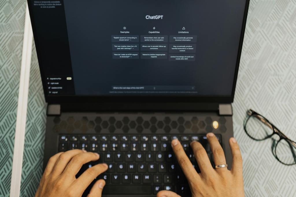 a person typing on their laptop to search on ChatGPT